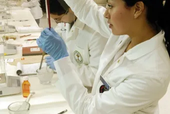 Pharmacist filling a vile