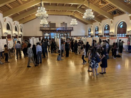 Students and faculty talking in a large ballroom 