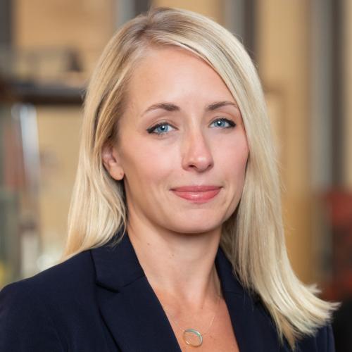 Woman with blonde hair gently smiling 