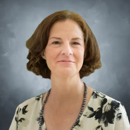 Woman in a white blouse with black flowers smiling